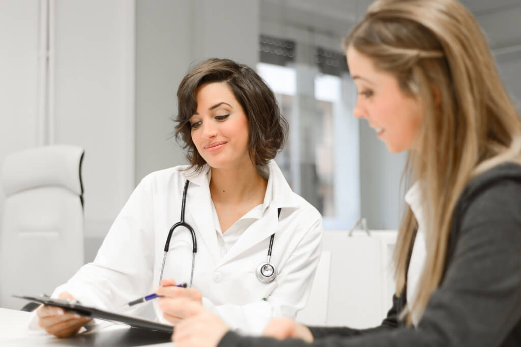 Female doctor explaining diagnosis to her female patient
