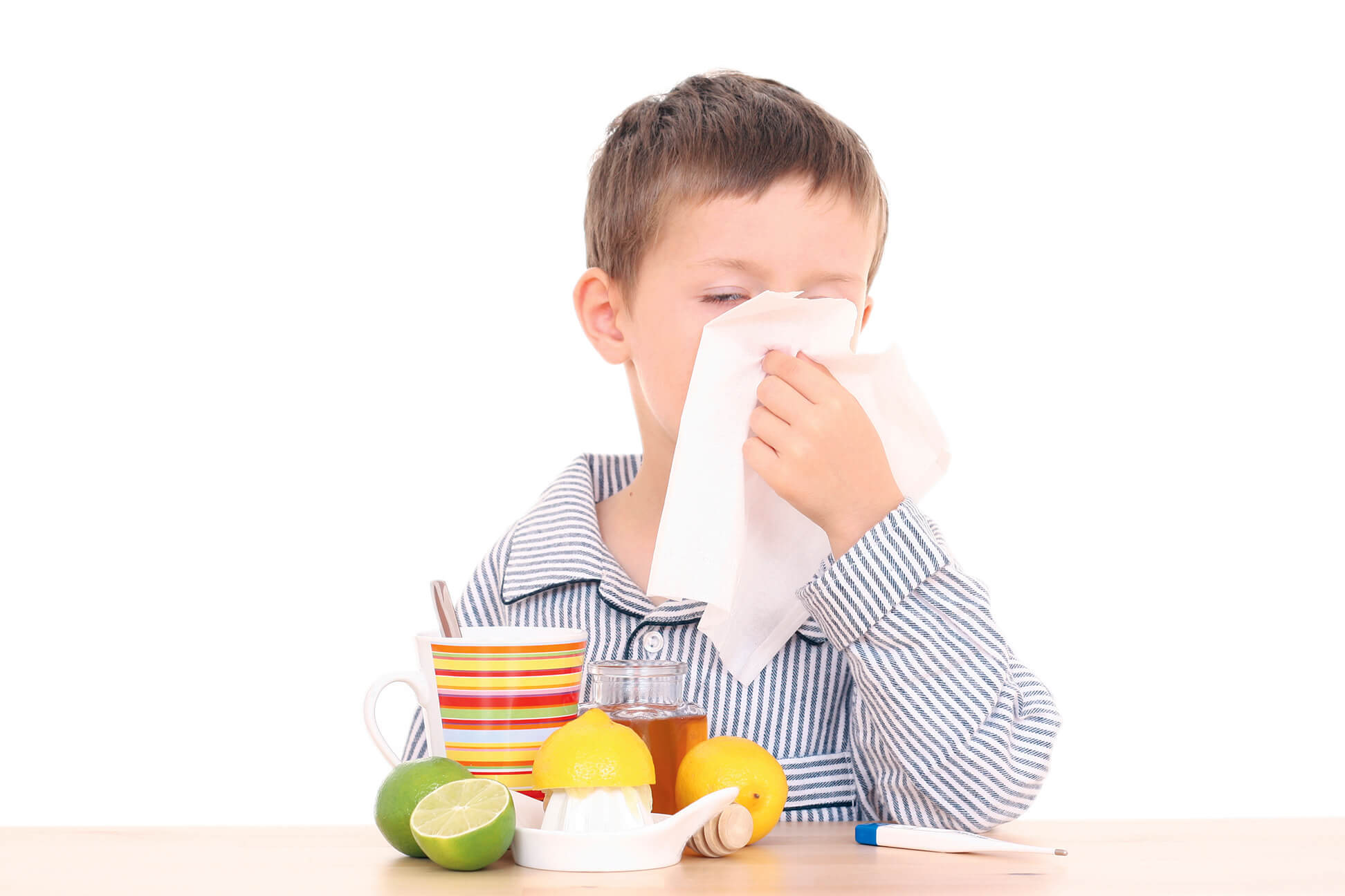 5-6 years old boy with thermometer and cold and flu remedy